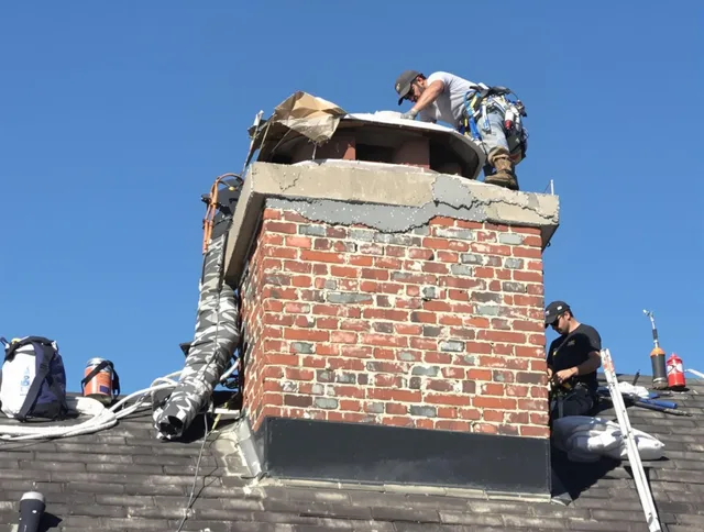 Newport Beach Chimney Sweep installing a custom chimney crown in Newport Beach, CA